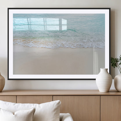 Soft shoreline with gentle aqua waves on smooth sand, ideal for minimalist coastal or pastel ocean-inspired home wall decor.