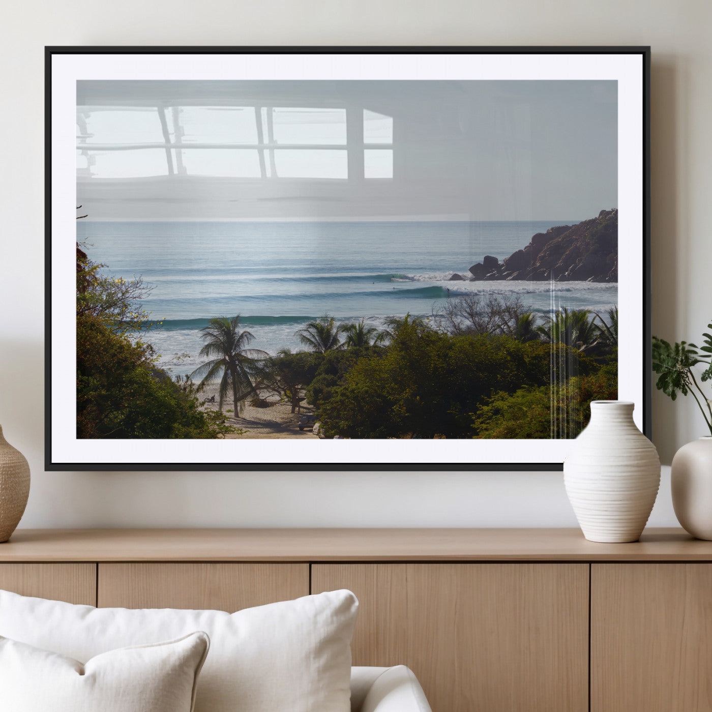 View of calm ocean waves with palm trees and a tropical coastline, ideal for coastal boho or beach-themed wall decor.