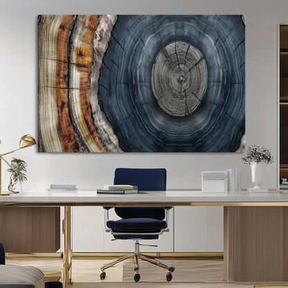 A stunning close-up of a tree trunk showing the intricate, circular growth rings, showcasing the natural textures and rich contrasts in deep blues, browns, and silvers.