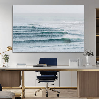 High-angle view of surfers lining up across layered ocean waves, ideal for minimal coastal or surf-inspired room decor.