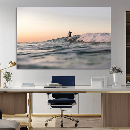 Framed canvas of a female surfer balancing on a wave at sunset, perfect for serene surf or ocean-inspired coastal decor.