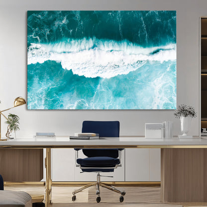Aerial view of turquoise ocean waves crashing with white foam, perfect for tropical coastal or modern beach-style home decor.
