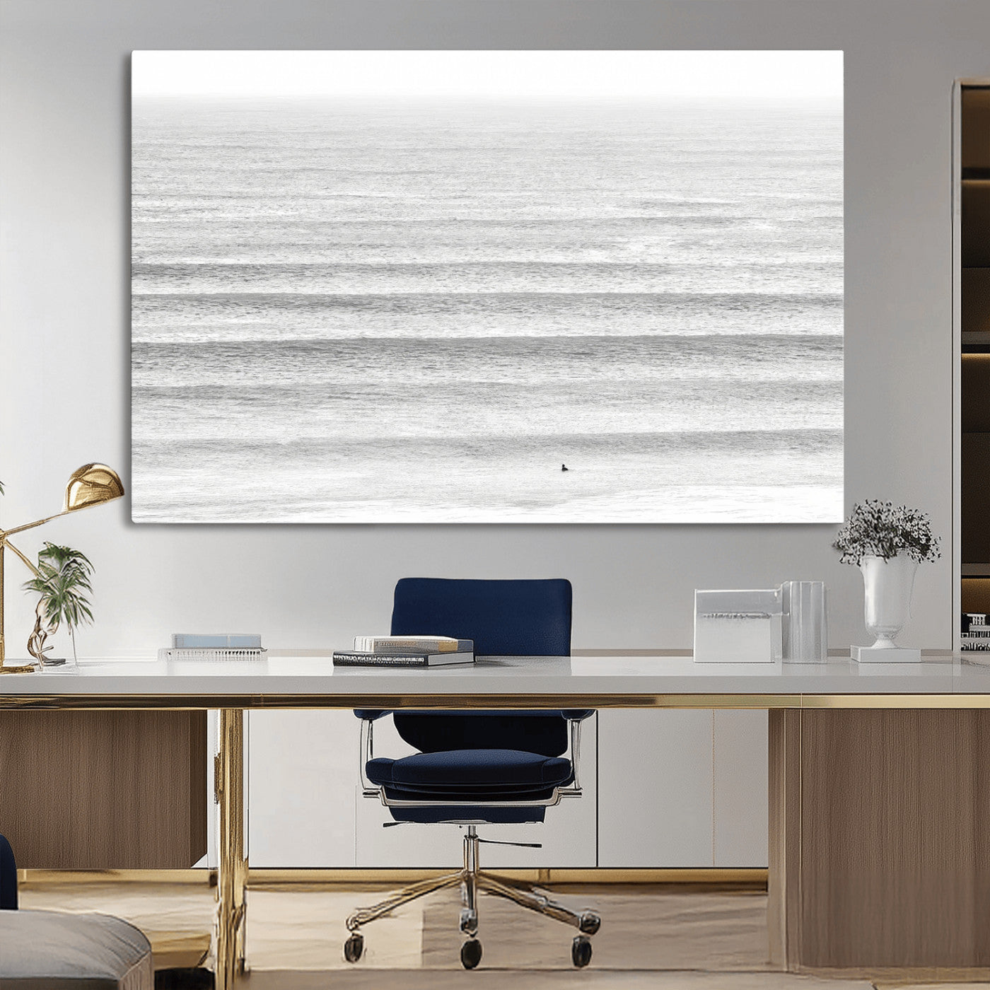 Monochrome photo of a lone surfer in calm layered waves, perfect for minimalist coastal or moody ocean-inspired wall decoration.