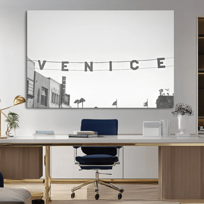 Black and white photo of Venice Beach sign and palm-lined street, perfect for urban coastal or minimalist LA-inspired wall decoration.