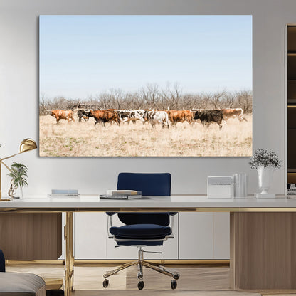 Framed wall art of Texas longhorn cattle walking through a dry, neutral-toned prairie, perfect for rustic farmhouse or western-themed home decor.