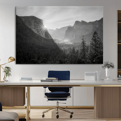 Black and white landscape of Yosemite with sun rays peeking over El Capitan, ideal for moody nature or modern rustic decor.