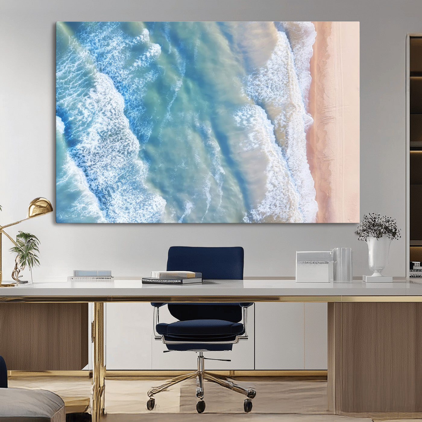 Aerial photo of soft blue waves meeting sandy shore, perfect for modern coastal or beach-themed decor with a light and tranquil aesthetic.