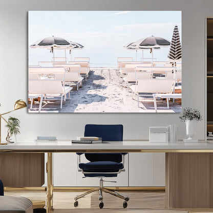 A serene minimalist beach scene featuring striped umbrellas, soft pastel sand, and an elegant lounge setup, creating a tranquil and stylish coastal retreat.