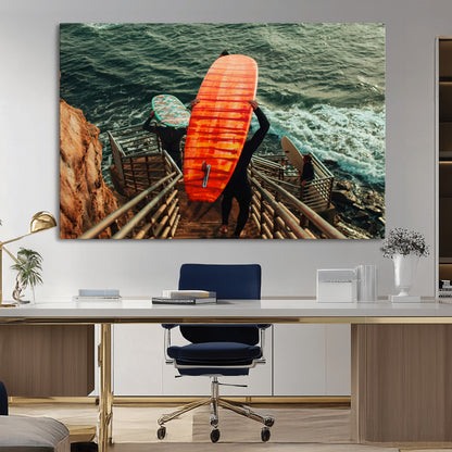 A surfer carrying a bold orange surfboard down a rugged staircase toward the ocean, bathed in golden hour light, capturing the energy of coastal adventure.