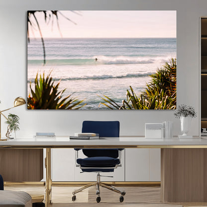 Canvas of a lone surfer riding a pastel wave at sunrise, perfect for tropical or coastal-themed spaces with a relaxed, airy vibe.