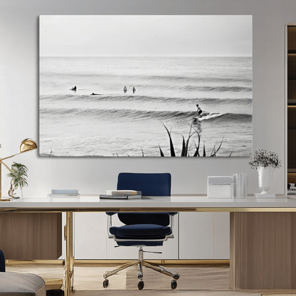 Monochrome canvas of surfers on calm ocean waves, ideal for minimalist coastal or beach-inspired interior decor.