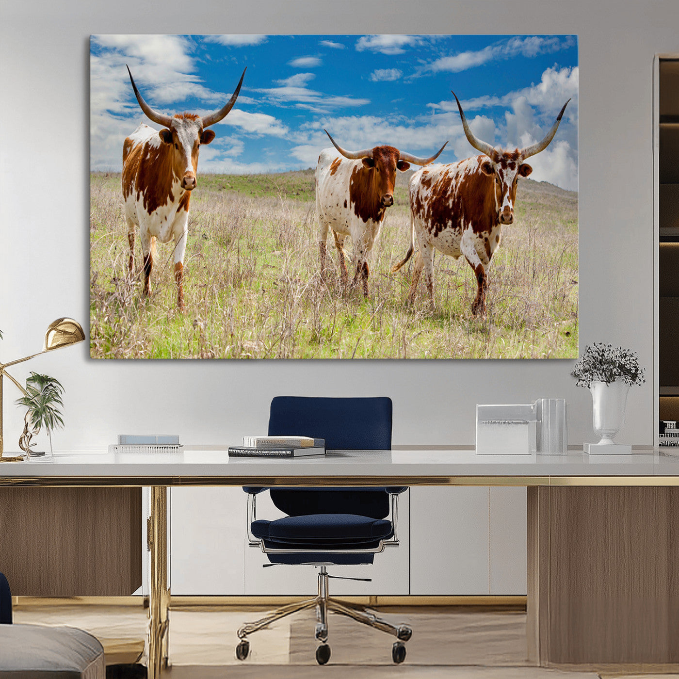 Three Texas longhorn cattle standing in dry grass under a bright blue sky, ideal for farmhouse or western rustic home decor.