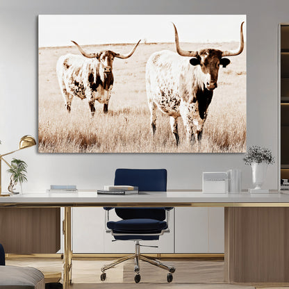 Two Texas longhorn cows standing in a sepia-toned pasture, evoking rustic charm perfect for farmhouse or western country interiors. (