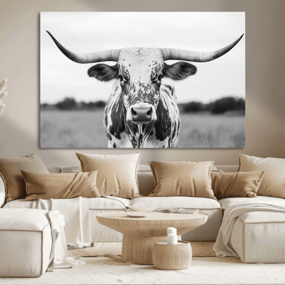 Capture the strength and elegance of nature with this striking black and white portrait of a longhorn cow. Its powerful presence makes a bold statement in any room.
