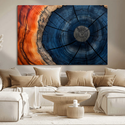 A captivating close-up of a tree trunk, showcasing its concentric rings in rich shades of blue, orange, and brown, highlighting the organic patterns of natural wood.