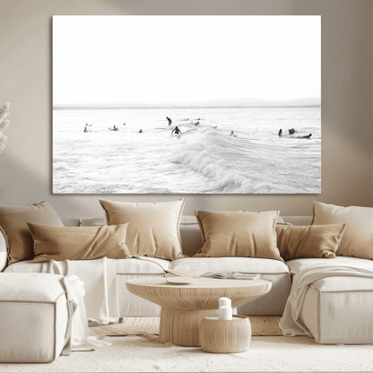 Monochrome photo of surfers riding and waiting on ocean waves, ideal for surf-themed or coastal energy wall decor.