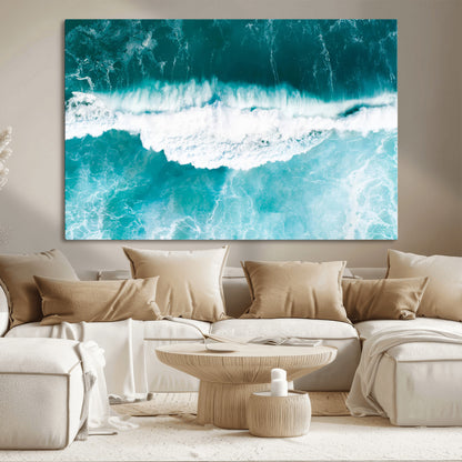 Aerial view of turquoise ocean waves crashing with white foam, perfect for tropical coastal or modern beach-style home decor.