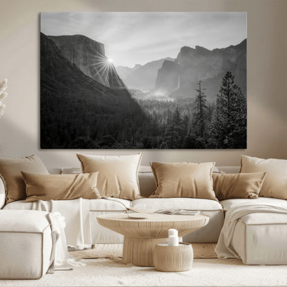 Black and white landscape of Yosemite with sun rays peeking over El Capitan, ideal for moody nature or modern rustic decor.