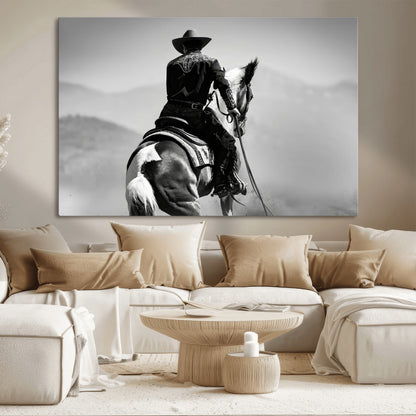 Black and white canvas of a cowboy on horseback with moody tones, perfect for rustic western or country-inspired home decor.