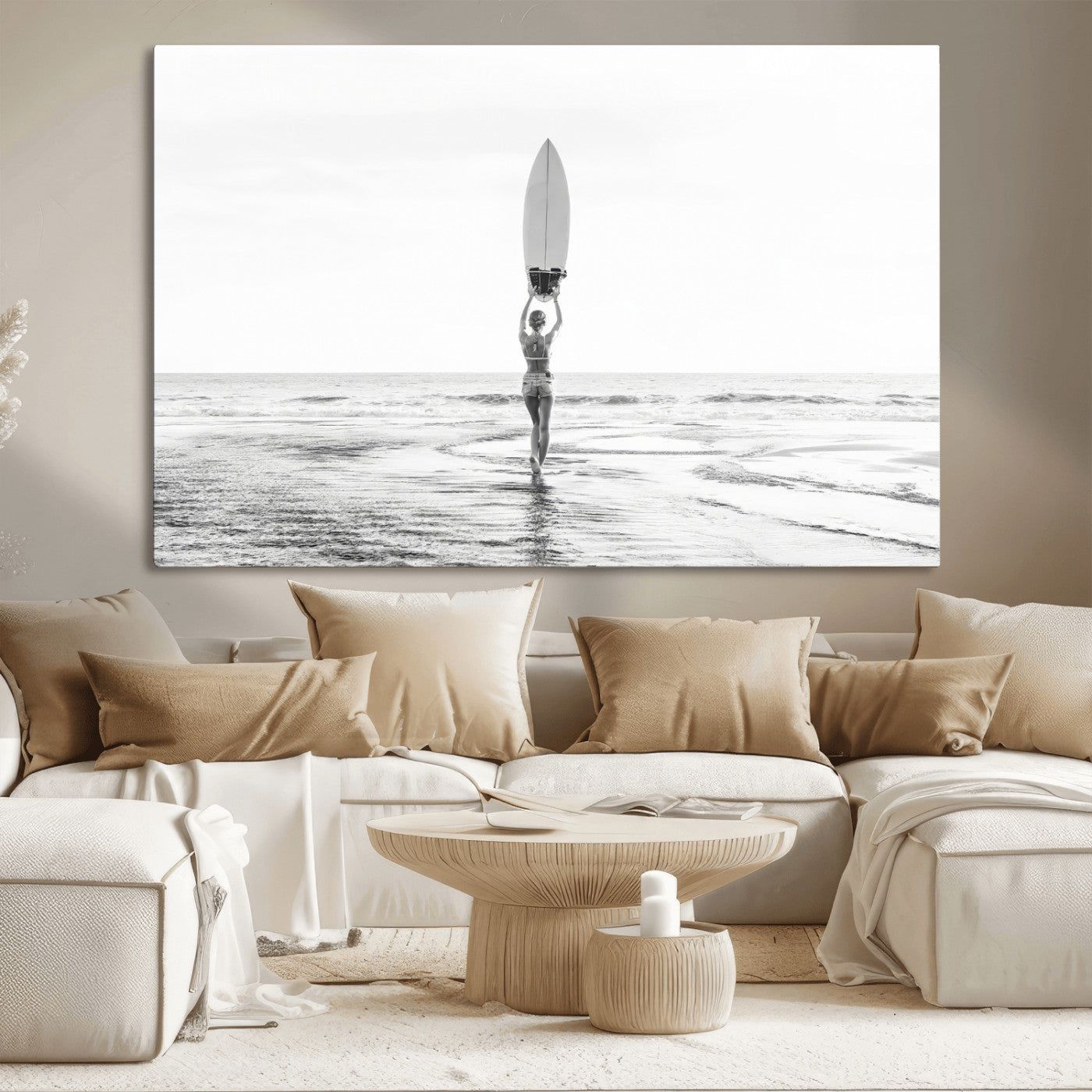 Black and white image of a female surfer holding a surfboard above her head while walking toward the ocean, creating a minimalist and bold coastal aesthetic.