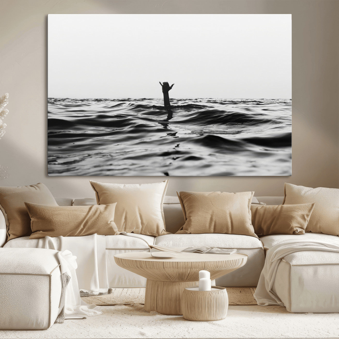 Black and white ocean with a hand making a surfer sign among dark waves, creating a dramatic and minimalist seascape with bold contrast.