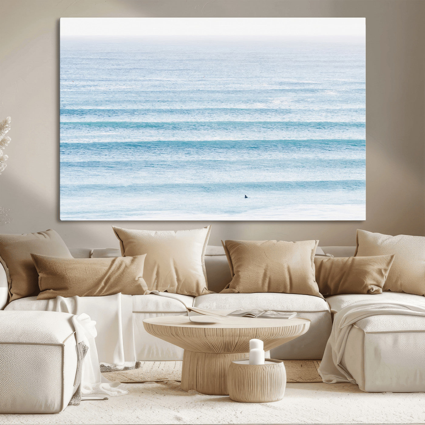 Minimalist ocean view with soft blue waves and a lone surfer, creating a serene and airy coastal aesthetic, perfect for tranquil home decor.