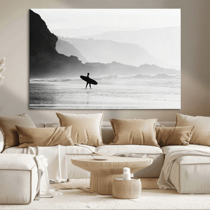 A lone surfer walking along a misty beach with cliffs in the background, carrying their board, capturing a serene and minimal ocean moment.