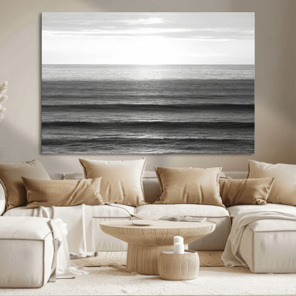 Minimalist black and white ocean view with layered waves reflecting sunlight, evoking a sense of calm and coastal serenity.