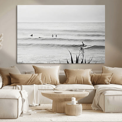 Monochrome canvas of surfers on calm ocean waves, ideal for minimalist coastal or beach-inspired interior decor.