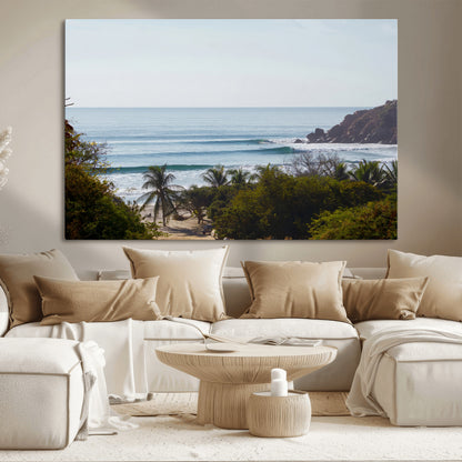 View of calm ocean waves with palm trees and a tropical coastline, ideal for coastal boho or beach-themed wall decor.