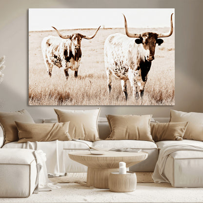 Two Texas longhorn cows standing in a sepia-toned pasture, evoking rustic charm perfect for farmhouse or western country interiors. (
