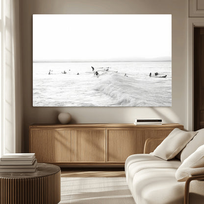 Monochrome photo of surfers riding and waiting on ocean waves, ideal for surf-themed or coastal energy wall decor.