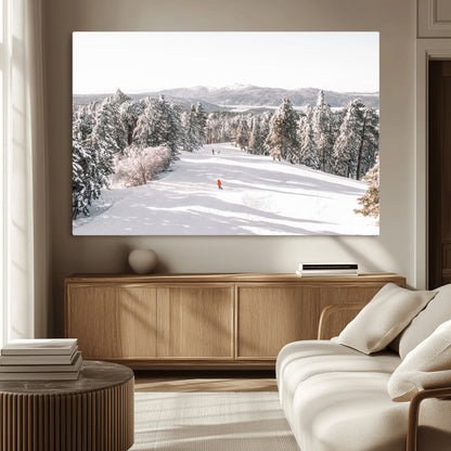 Bright ski trail lined with snow-covered pines and a skier in orange, perfect for alpine adventure or winter sports-inspired decor.