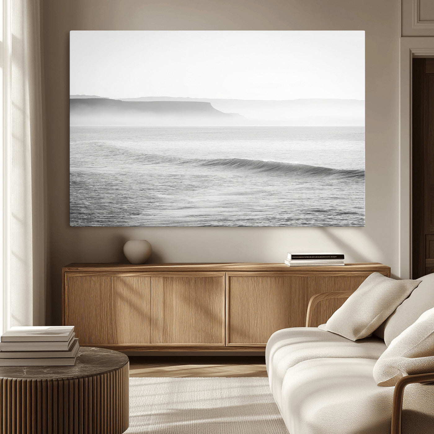 A black and white minimalist seascape featuring soft rolling waves and misty distant cliffs, creating a serene and timeless coastal atmosphere.