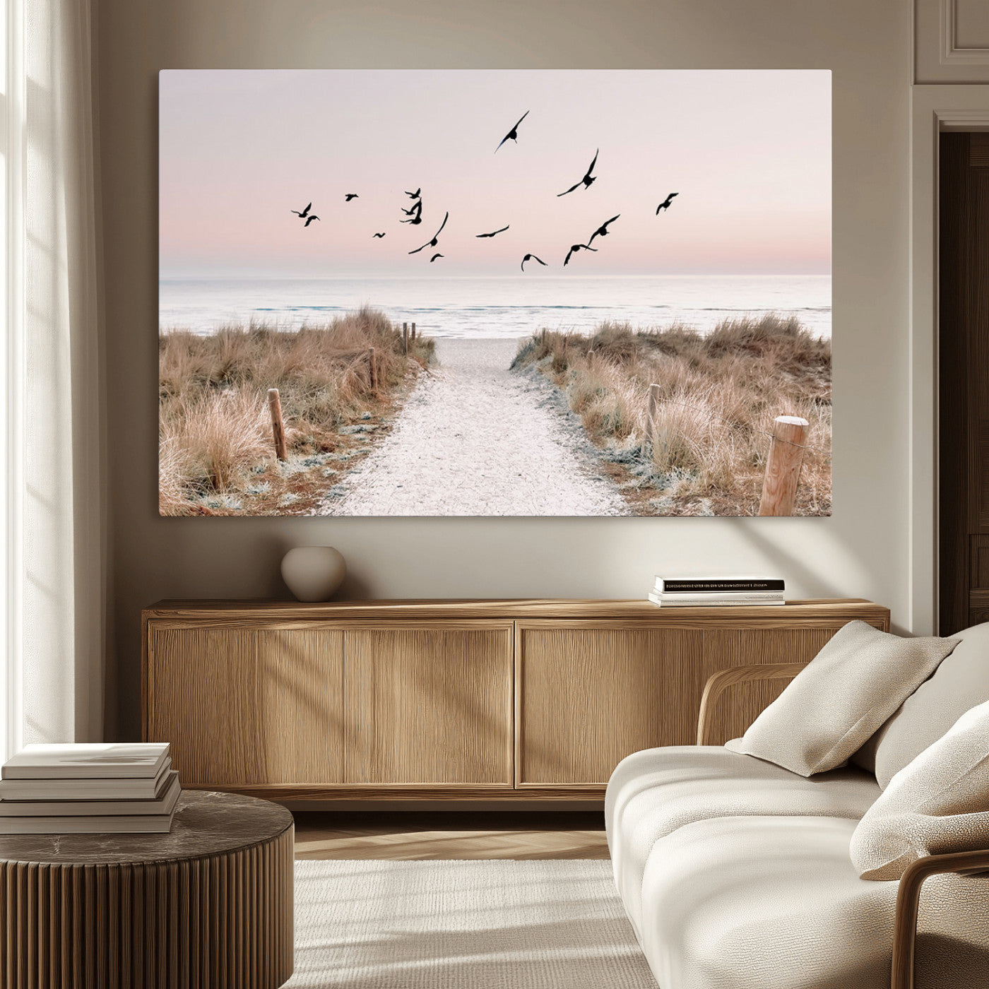 A peaceful coastal pathway leading to the ocean, with birds flying across a soft pastel sky, creating a calm and scenic beach atmosphere.