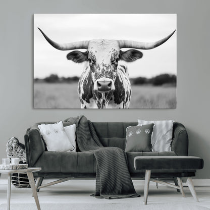 Capture the strength and elegance of nature with this striking black and white portrait of a longhorn cow. Its powerful presence makes a bold statement in any room.