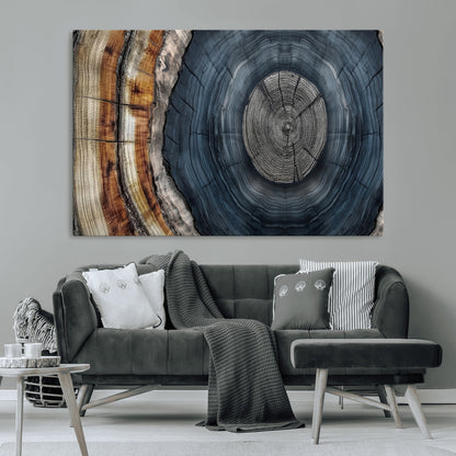 A stunning close-up of a tree trunk showing the intricate, circular growth rings, showcasing the natural textures and rich contrasts in deep blues, browns, and silvers.