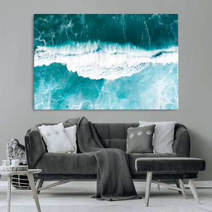 Aerial view of turquoise ocean waves crashing with white foam, perfect for tropical coastal or modern beach-style home decor.
