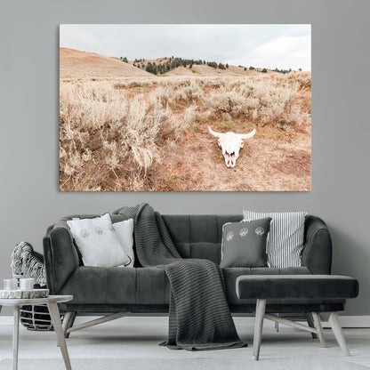 Rustic bull skull on dry sagebrush field under soft light, ideal for western minimal or desert prairie-style wall decoration.