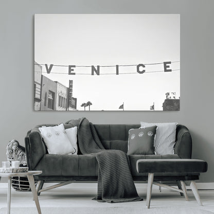 Black and white photo of Venice Beach sign and palm-lined street, perfect for urban coastal or minimalist LA-inspired wall decoration.
