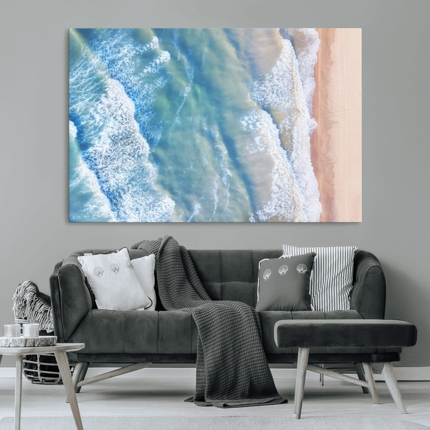 Aerial photo of soft blue waves meeting sandy shore, perfect for modern coastal or beach-themed decor with a light and tranquil aesthetic.