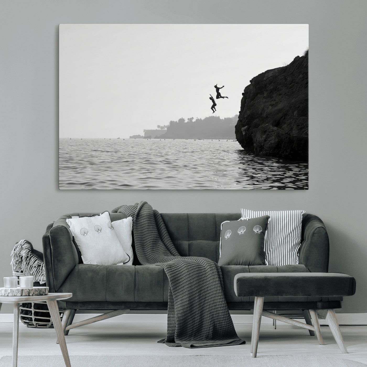 Black and white canvas of two figures cliff jumping into the sea, captured with moody tones, ideal for modern coastal or adventure-themed home decor.   2/2