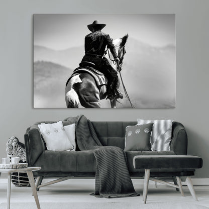 Black and white canvas of a cowboy on horseback with moody tones, perfect for rustic western or country-inspired home decor.