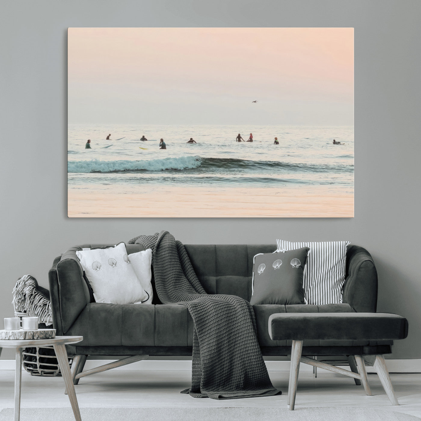 Dreamy photo of surfers waiting on soft pastel waves under a pink sunset sky, ideal for soft coastal minimalist or serene ocean-themed home decor.