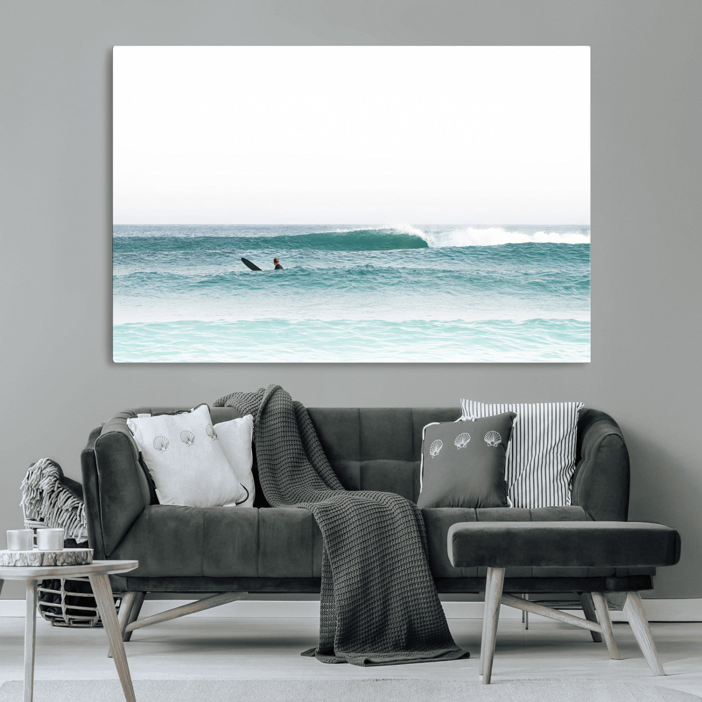 Minimalist photo of a lone surfer on calm aqua waves under bright sky, perfect for Scandinavian coastal or serene ocean-inspired home decor.