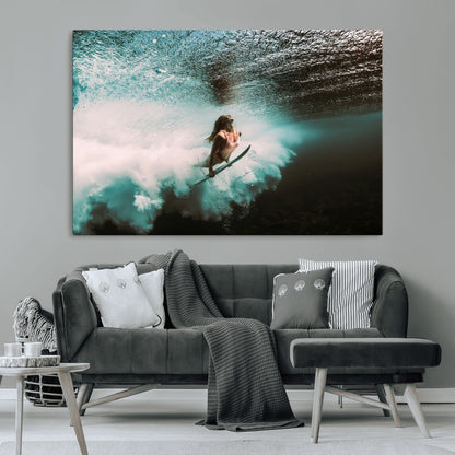Vibrant underwater photo of a female surfer diving through turquoise waves, perfect for coastal boho or surf-inspired home decor.