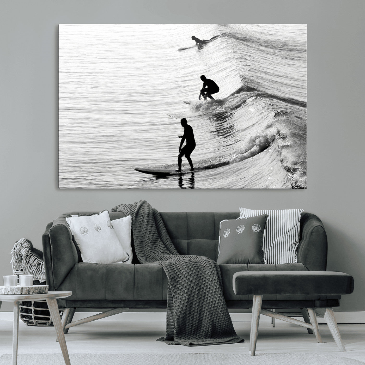 Black and white photo of surfers riding waves in a moody, high-contrast scene, ideal for modern coastal or surf-inspired home decor.