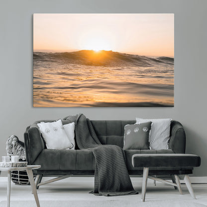 Ocean waves glowing under a warm golden sunset, reflecting soft light and calm movement, perfect for warm minimalist coastal interiors.
