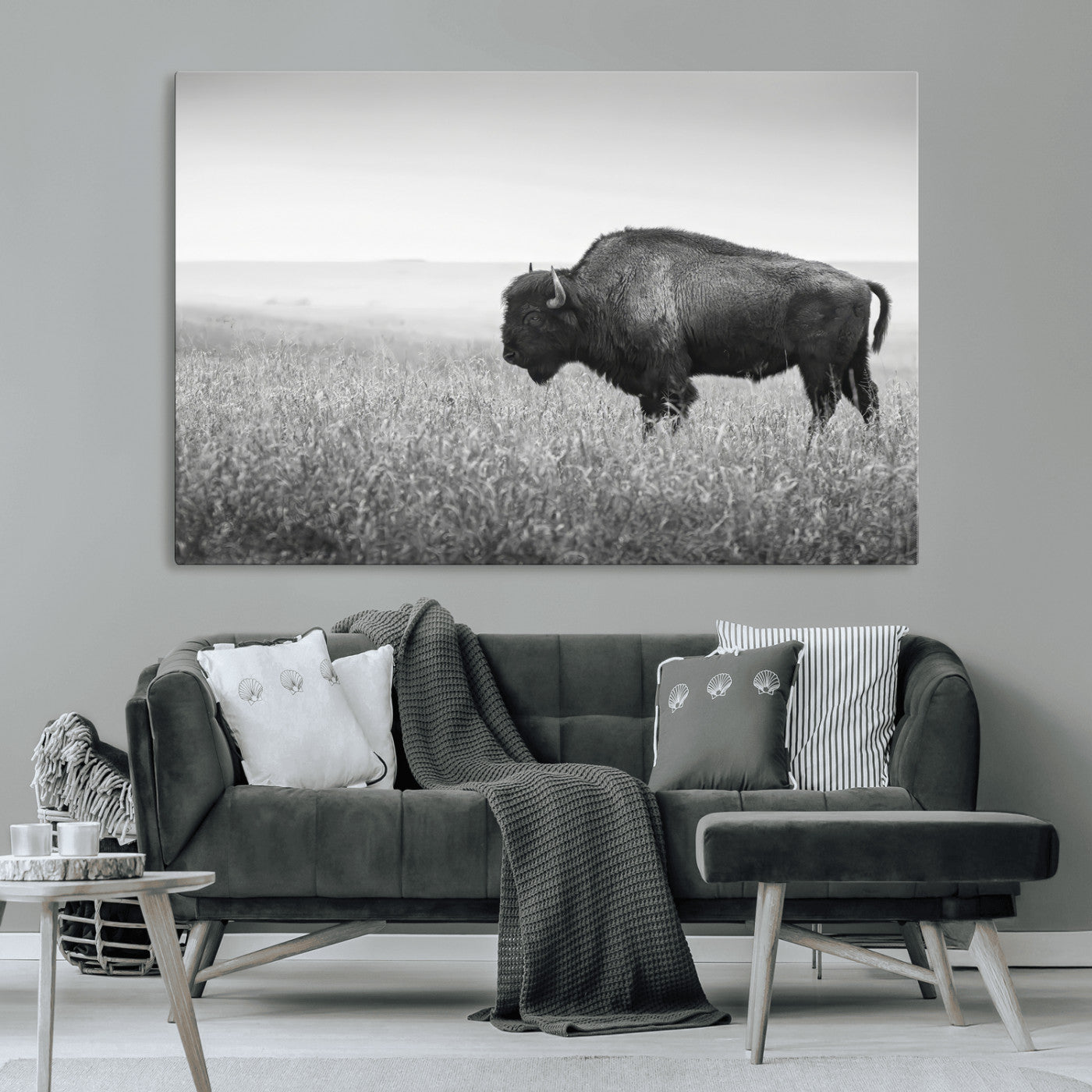 A black and white photograph of a majestic bison standing in a vast grassy prairie, evoking a sense of wilderness and strength.
