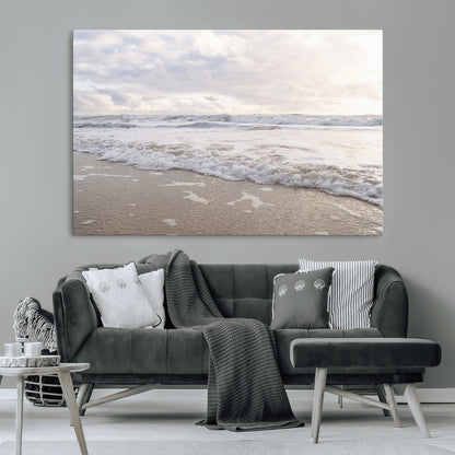 Peaceful ocean waves rolling onto the sandy shore under soft light, perfect for neutral or coastal minimalist decor themes.